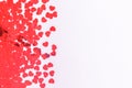 Glitter heart confetti border on light grey. Valentine day concept. Trendy minimalistic flat lay design background