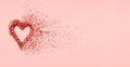 Glitter heart dissolving into pieces on pink background. Valentines day, broken heart and love emergence concept . Living coral Royalty Free Stock Photo