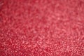 Glitter red background. Texture foil and confetti bokeh, light of red dust. Festive party Christmas and new year's eve Royalty Free Stock Photo