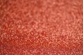 Glitter red background. Texture foil and confetti bokeh, light of red dust. Festive party Christmas and new year's eve Royalty Free Stock Photo