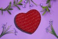 glitter red heart box with flowers on purple background . Royalty Free Stock Photo