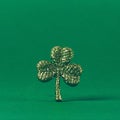 Glitter shamrock on green paper background. St Patricks day symbol. Irish National holiday concept