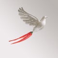 Glitter toy dove with fresh bird eye chillies against light gray background. Modern minimal abstract concept