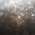 Glitter vintage lights background. dark gold and black. defocused