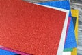 Glittered colorful Eva foam sheets, colored cardboard, rubber pad, sponge papers for school arts and crafts, pile of multicolored