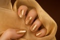 Glittered golden nails manicure