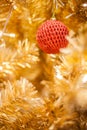 Glittering Bauble with Glowing Sparkling Gold defocused Light bokeh Illumination background with decorated Christmas Tree. Royalty Free Stock Photo