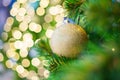 Glittering Baubles with Glowing Sparkling Gold defocused Light bokeh Illumination background with decorated Christmas Tree. Royalty Free Stock Photo