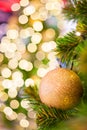 Glittering Baubles with Glowing Sparkling Gold defocused Light bokeh Illumination background with decorated Christmas Tree. Royalty Free Stock Photo