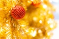 Glittering Baubles with Glowing Sparkling Gold defocused Light bokeh Illumination background with decorated Christmas Tree. Royalty Free Stock Photo