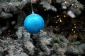 Glittering blue hanging ball decoration on Christmas tree Royalty Free Stock Photo