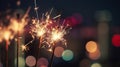 Glittering burning sparkler with multicolor defocused night city background.