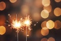Glittering burning sparklers against blurred colorful bokeh background. Celebrating Christmas and New Year\'s Eve