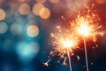 Glittering burning sparklers against blurred colorful bokeh background. Celebrating Christmas and New Year\'s Eve