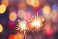 Glittering burning sparklers against blurred colorful bokeh background. Celebrating Christmas and New Year\'s Eve