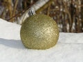 Glittering Christmasball in the snow Royalty Free Stock Photo