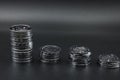 Glittering coins stacked on a black background