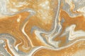 Metallic gold and shimmery silver coalesce to create this abstract background.