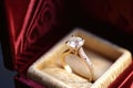 glittering golden engagement ring inside a velvet box