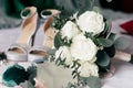 Glittering high-heeled bridal shoes, a bridal bouquet of roses and a gemstone bridal ring Royalty Free Stock Photo