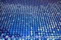 Glittering shiny blue sequin wall decoration for texture and background.