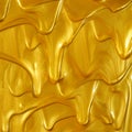 Glittering shiny metallic gold paint flowing and dripping downward making a golden background