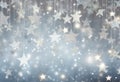 Glittering silver stars suspended against a soft blue bokeh background Royalty Free Stock Photo