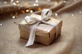 a glittering silver wrapped present box on a plain burlap fabric