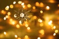 Glittering snowflake on a yellow background. Golden lights of the holiday background. Bokeh, blurring, sparks. New Year Royalty Free Stock Photo
