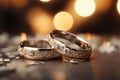 Glittering vows Silver and gold wedding rings on bokeh background