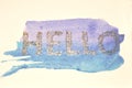 Glittering word - Hello - on blue watercolor splash in nostalgic colors, made with golden glitter Royalty Free Stock Photo