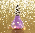 Glittery gold background with 3D perfume bottle