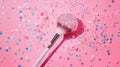 Sparkling Makeup Brush with Pink and Blue Glitter Confetti on a Pink Background Royalty Free Stock Photo