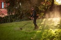 Globa Park, Dnepropetrovsk, Ukraine - 10/15/2020: Autumn work in the park. The gardener cuts the grass before winter