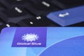 Global Blue closeup logo on plastic card against black ThinkPad Royalty Free Stock Photo