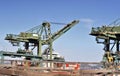 Crane lifting heavy cargo into a container at a busy port, symbolizing global and international trade Royalty Free Stock Photo