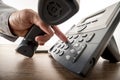 Global communication concept - closeup of male hand dialing a te Royalty Free Stock Photo