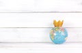 Global Dominance: Crowned World Globe on White Rustic Background Representing Leadership Royalty Free Stock Photo