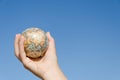 Global earth in hand on blue sky background, Asia Royalty Free Stock Photo