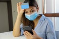Global Economic Crisis Covid-19 Pandemic Coronavirus. Shocked desperate business woman with surgical mask looking on mobile phone Royalty Free Stock Photo
