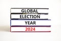 Global election year 2024 symbol. Concept words Global election year 2024 on beautiful books. Beautiful white table white