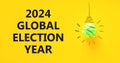2024 global election year symbol. Concept words 2024 global election year on beautiful yellow paper. Beautiful yellow background. Royalty Free Stock Photo
