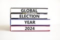 Global election year 2024 symbol. Concept words Global election year 2024 on beautiful books. Beautiful white table white