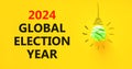 2024 global election year symbol. Concept words 2024 global election year on beautiful yellow paper. Beautiful yellow background. Royalty Free Stock Photo