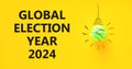 Global election year 2024 symbol. Concept words Global election year 2024 on beautiful yellow paper. Beautiful yellow background. Royalty Free Stock Photo