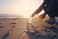 Global environmental pollution A volunteer collects plastic bottles on the ocean shore Legs close. Generative AI