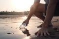 Global environmental pollution A volunteer collects plastic bottles on the ocean shore Legs close. Generative AI