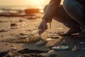 Global environmental pollution A volunteer collects plastic bottles on the ocean shore Legs close. Generative AI