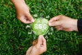 Global ESG icon concept with teamwork. Contribute to saving the environment in a heart shape and in a sustainable business on