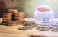 GLOBAL FINANCIAL CONCEPT. Stack of coins and globe with graph icons over a blur map background. Selective focus Royalty Free Stock Photo